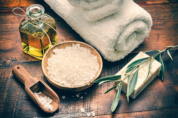 Spa setting with natural olive soap and sea salt Spa setting with natural olive soap and sea salt on wooden table bath salt photos stock pictures, royalty-free photos & images