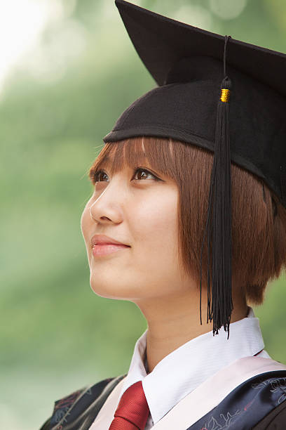 istock Young Woman Graduating From University, Looking-Up Horizontal Portrait 455686819