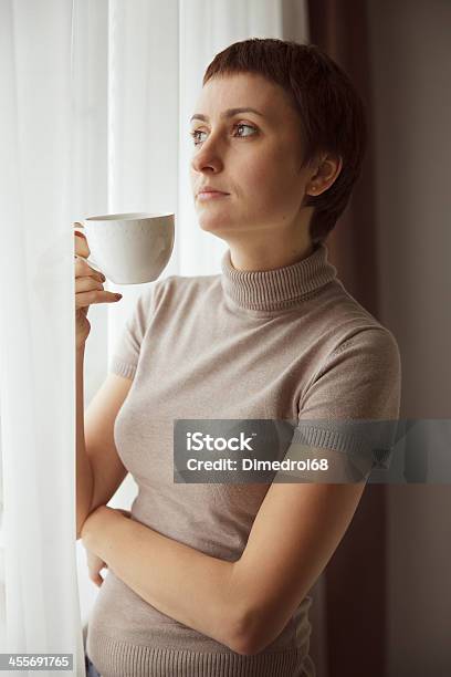 Charming Pretty Woman Drinking Coffee Stock Photo - Download Image Now - Adult, Adults Only, Affectionate