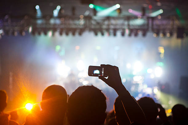 istock A guy taking a picture at a concert 455695111