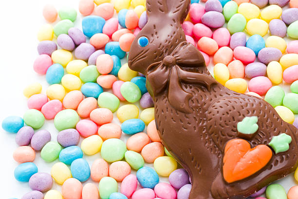 Easter bunny Chocolate Easter bunny with other Easter candies. chocolate bunny stock pictures, royalty-free photos & images
