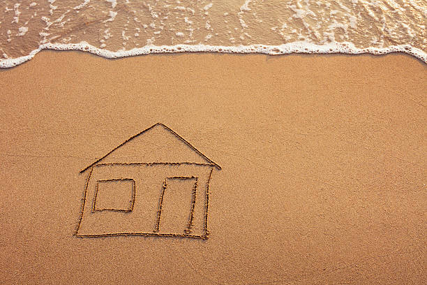 istock house painted on the beach 455700239