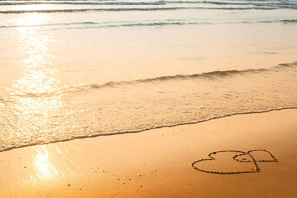 istock Hearts drawn on the sand of a beach 455713865