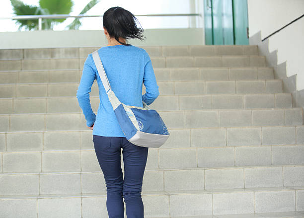 istock woman college student running on stairs 455769455