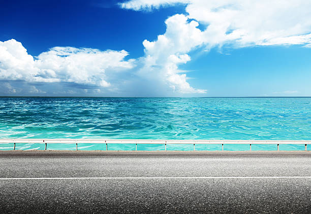 istock Bright blue sea next to the asphalt road 455773515