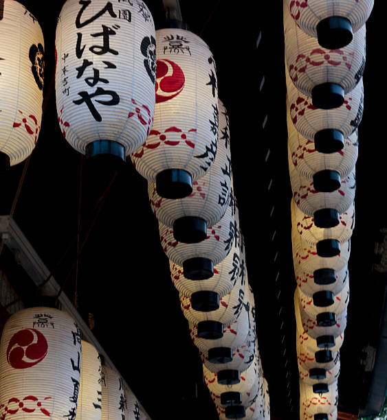 istock Rrows of white  japanese lanterns, hanging from a ceil 455847035