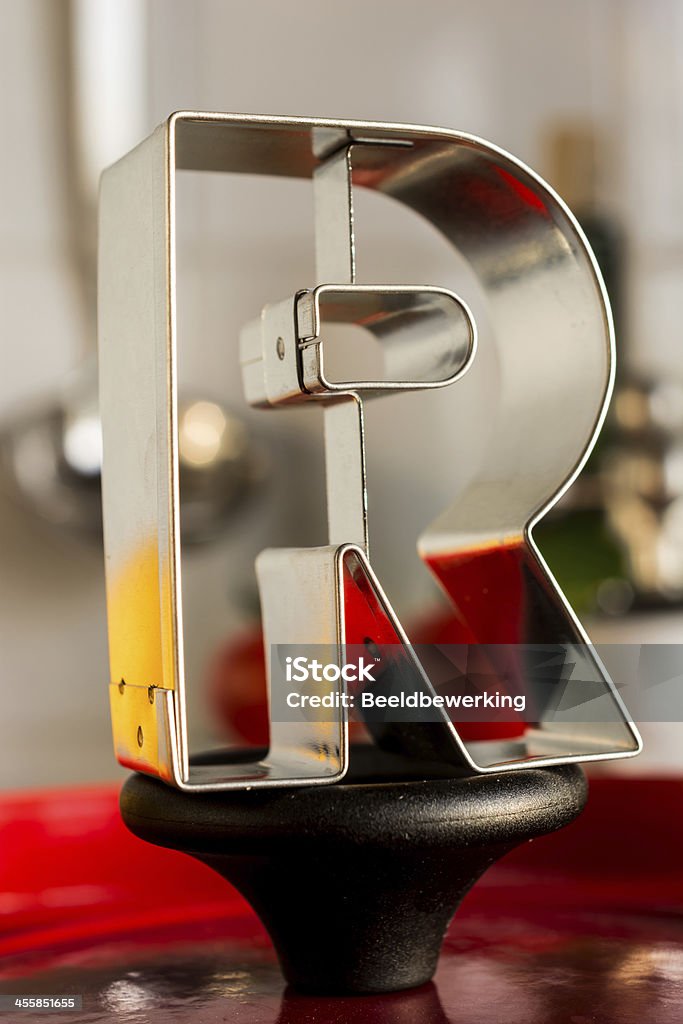 Letter R kitchen alphabet Alphabet cutter R placed on  casserole handle with kitchen bokeh Alphabet Stock Photo