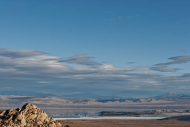 Mono Lake Basin Mono Lake in the eastern Sierra Nevada Range of California is a large, shallow saline soda lake formed at least 760,000 years ago. Because it has no outlet to the sea, high levels of salt have accumulated in the lake. These salts also contribute to the alkalinity of the lake. The lake level has dropped because water entering the lake is being being diverted into the Los Angeles aqueduct. Tufa towers, made of limestone, have appeared in the lake as the water has receded. This scene was photographed on a fall day as the sagebrush and grasses took on the glow of the setting sun. Mono Lake is in the Inyo National Forest near Lee Vining, California, USA. jeff goulden mono lake stock pictures, royalty-free photos & images