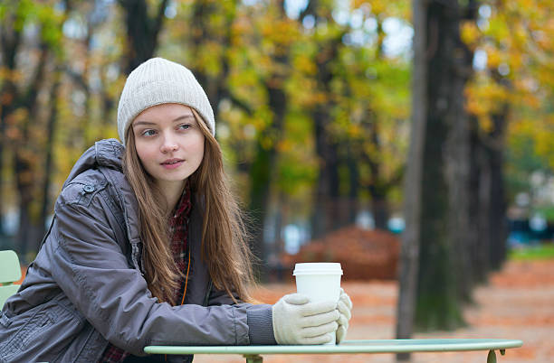 istock Girl drinking coffee in an outdoor cafe 456008093