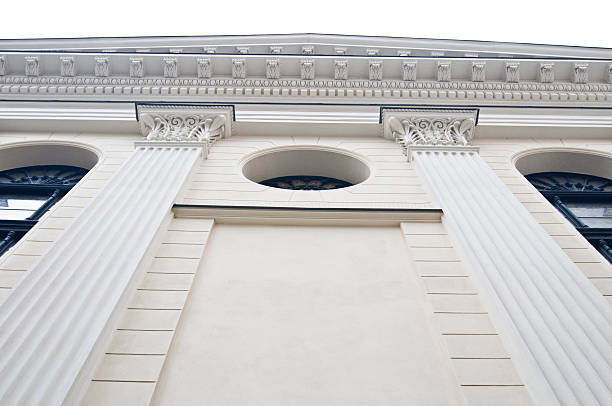 Old building in modern city with tymanum and pillars stock photo