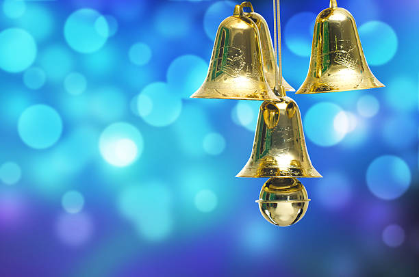 istock Gold christmas jingle bells on a blue bokeh background. 456013969