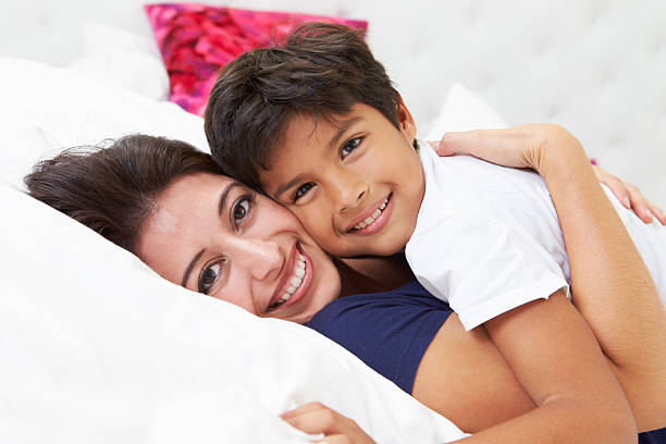 istock Mother And Son Lying In Bed Together 456021731