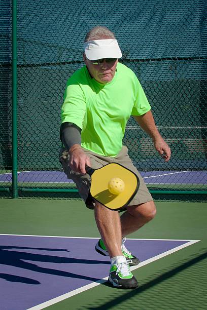 istock Pickleball Action - Senior Male Player Hitting Backhand Stoke 456026571