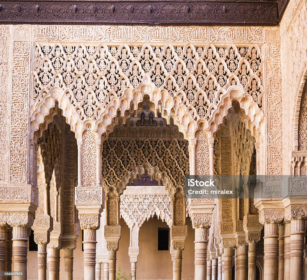 Detail of Ornate Decoration at Alhambra Palace in Granada, Spain Detail of ornate decoration at Alhambra Palace in Granada, Spain. This photograph was taken at the entrance to Patio de los Leones (Court Of The Lions). Alhambra - Spain Stock Photo