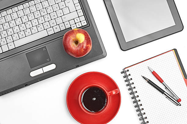 istock Laptop and office supplies on white 456032425