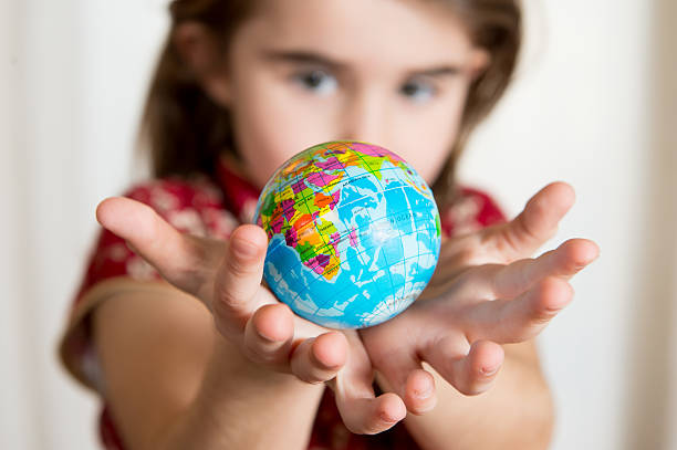 Cute girl holding little World Globe on her Hands Cute little girl holding World Globe on her Hands preschooler caucasian one person part of stock pictures, royalty-free photos & images