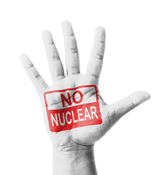 Open hand raised, No Nuclear sign painted stock photo