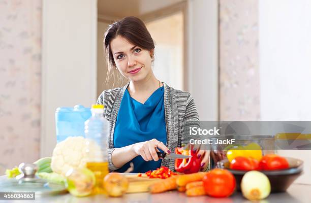 Beautiful Woman Cuts Pepper Stock Photo - Download Image Now - 20-29 Years, Adult, Adults Only