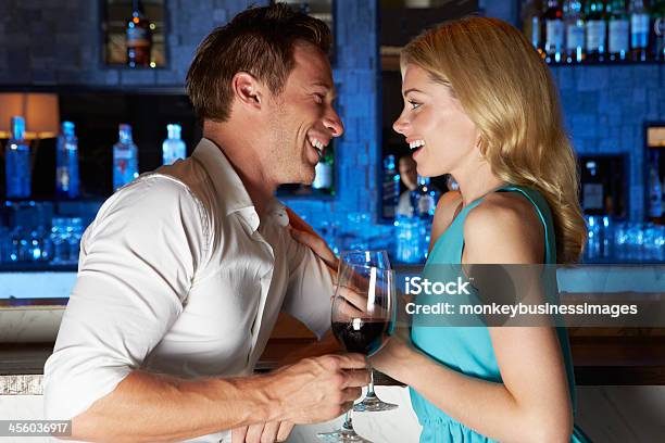 Couple Enjoying Drink In Bar Stock Photo - Download Image Now - Alcohol - Drink, Bar Counter, Casual Clothing