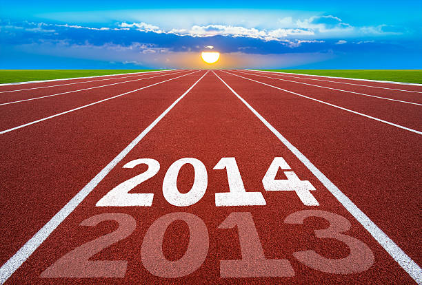 istock New Year 2014 on running track concept with sun, sky. 456037601