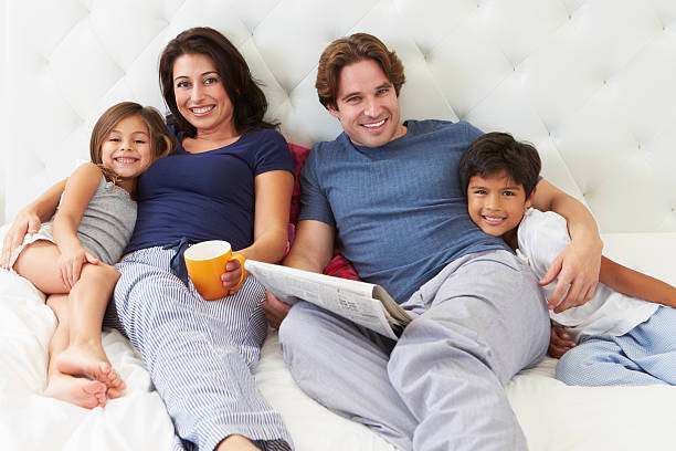 istock Family Relaxing In Bed With Coffee And Newspaper 456037943