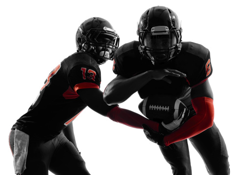 two american football players passing play action in silhouette shadow on white background