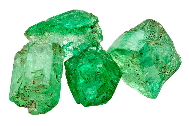 Four emerald crystals Four rich green emerald crystals on white emerald gemstone stock pictures, royalty-free photos & images