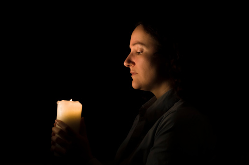 woman holding a candlelight in her hands