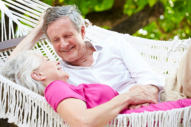 istock Senior Couple Relaxing In Beach Hammock 456054037