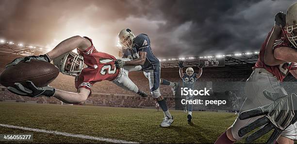 American Football Player In Mid Air Touchdown Tackle Stock Photo - Download Image Now