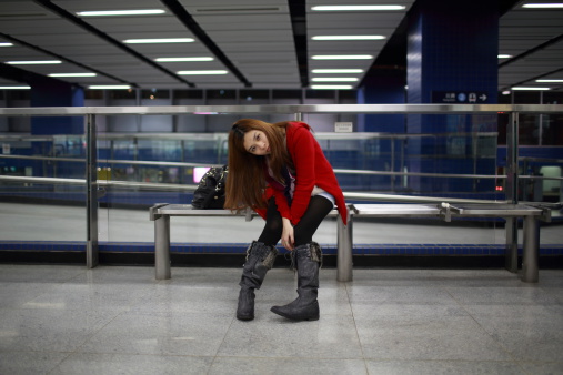 girl waiting someone in the modern train platform in hong kong mtr station