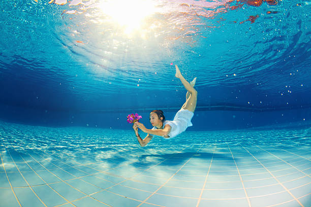 istock girl with flower underwater 456067131