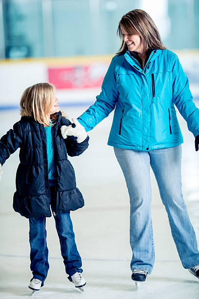 istock Mother ice skating with daughter 456067965