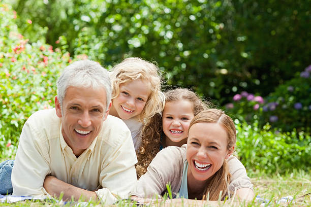 istock Family smiling while lying together in a garden 456068381