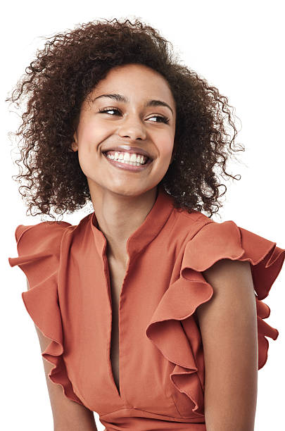 Feeling fantastic Studio shot of a cute young african american woman looking away and smiling woman waist up stock pictures, royalty-free photos & images