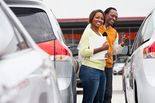 African American couple shopping for new car.