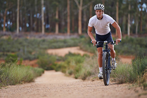 Man riding electric bike fast on mountain road, blurred motion view