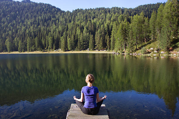 istock meditation near the lake 456082205