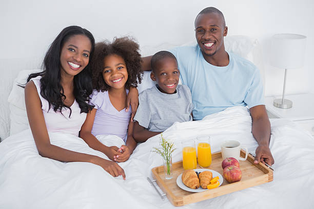 istock Content family having breakfast in bed looking at camera 456082217