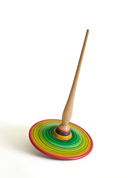 istock Child's wooden spinning top on white. 456082733