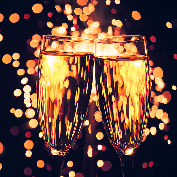 istock champagne glasses against christmas sparkler background 456083021