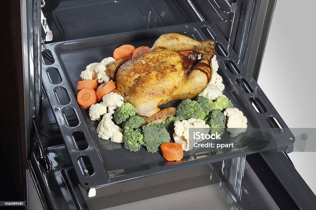 Roasted chicken Roasted chicken with vegetables in the oven Baked Stock Photo