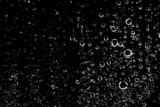 istock Photograph of rain drops falling on a black background 456091619