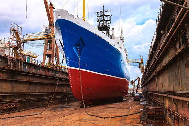 Ship being fixed on a dry dock Cargo ship is being renovated in shipyard Gdansk, Poland. gdansk photos stock pictures, royalty-free photos & images