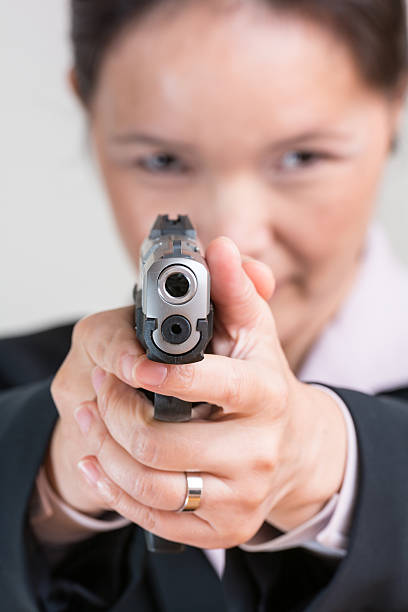 istock Woman aiming a hand gun 456096293