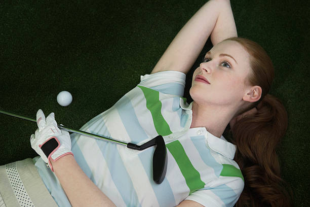 istock Woman Lying On Course With Golf Club And Ball 456096419