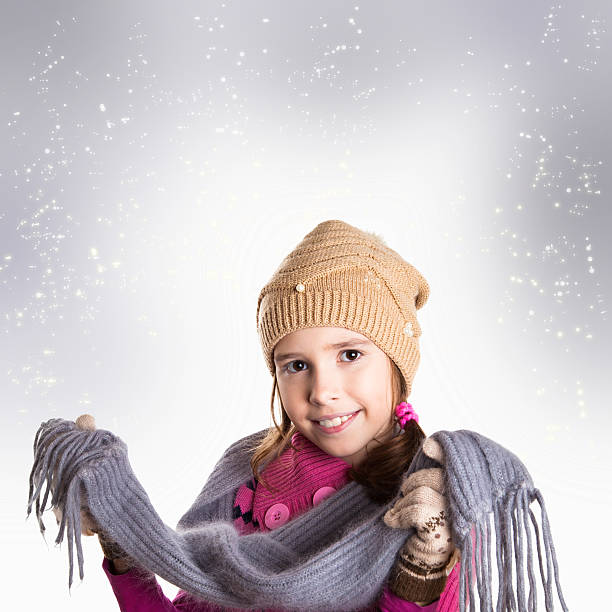 Happy little girl with scarf in Christmas background