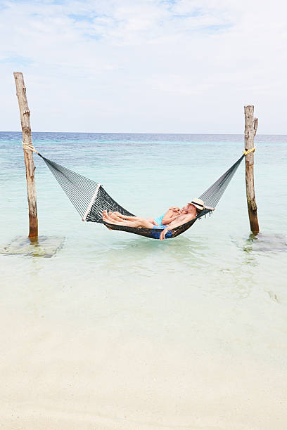 istock Senior Couple Relaxing In Beach Hammock 456100833