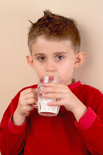 istock little boy with glass of milk 456101251