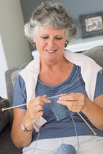 istock Happy mature woman knitting 456101361
